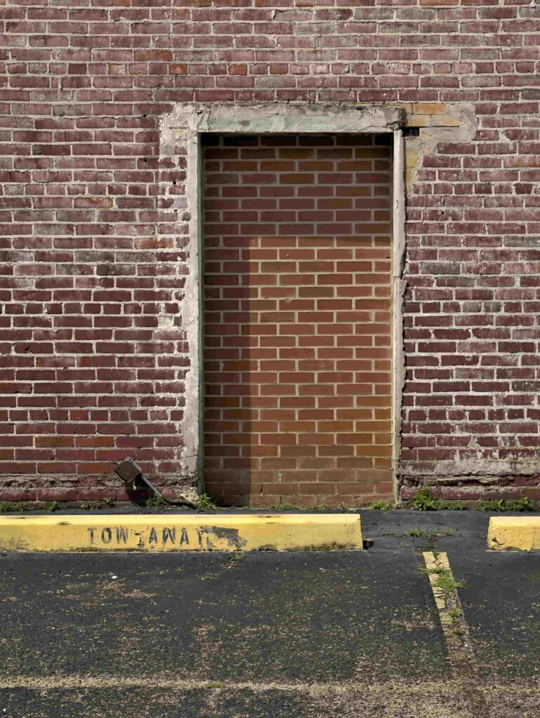 a door covered by a brick wall 